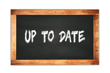 Fototapeta premium UP TO DATE text written on wooden frame school blackboard.