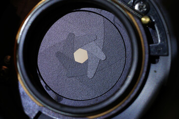 Closeup shot of the diaphragm of a camera lens aperture - obrazy, fototapety, plakaty