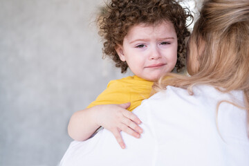 cute curly little child girl crying hug her mother