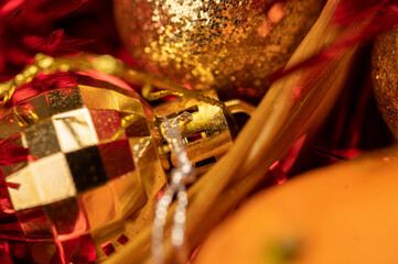 New Year and Christmas decorations of the festive table with tangerines, tinsel and Christmas balls. Close-up, selective focus.