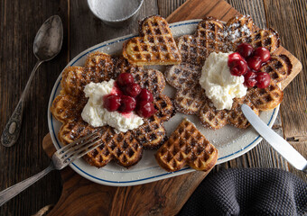 Waffles with cherries and whipped cream