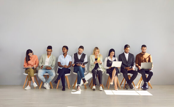 Modern way to communicate. Woman in row with people who came for interview and are busy reading resumes or surfing internet. Concept of human resources, employment, customers and electronic devices.