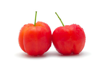 Fresh red acerola cherries with droplets of water isolated on white background.