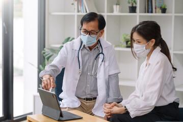 Doctor described the symptoms to the female patient in detail and Treatment guidelines at the...