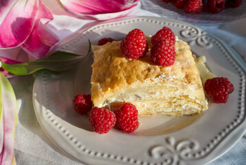 delicious napoleon cake with raspberries. Puff pastry with raspberry on plate