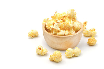 Caramel popcorns in wooden bowl isolated on white background with copy sapce.