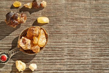 Frankincense resin on wooden background with empty space