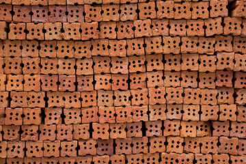 Pile of new red brick layer prepared for construction texture background
