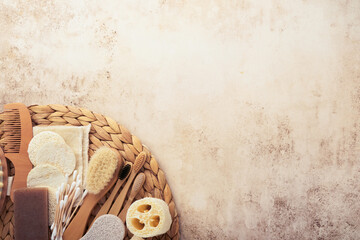 Zero waste concept. Set of eco friendly bathroom accessories on sand colors concrete beige background with deep shadows. Eco friendly and reuse concept. Top view.