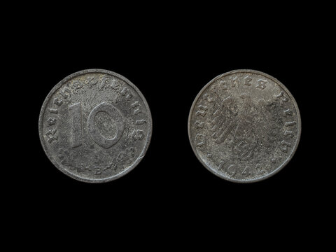 Top view of the front and back of a historic Nazi Germany reichsmark coin on a black background
