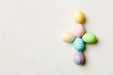 holiday preparation Multi colors Easter eggs on colored background, cross show the religious and secular side of Easter. Pastel color Easter eggs. holiday concept with copy space