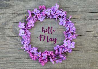 Hello May greeting card with fresh lilac flowers on old  wooden background.Springtime concept.