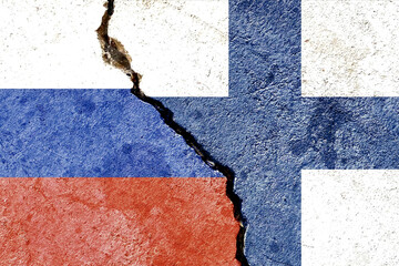 Russia vs Finland flags isolated on cracked dirty wall background