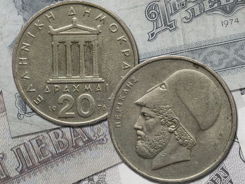 Both sides of vintage Greek drachma coins.