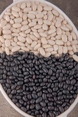 Organic black and white beans in oval plate, organic pattern