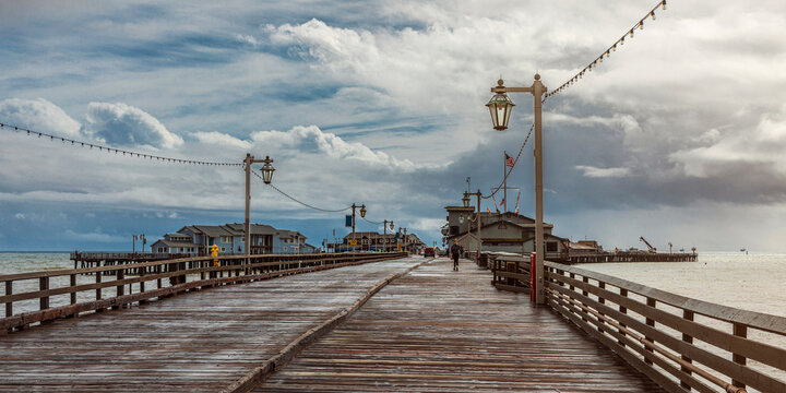 The iconic Stearns Wharf, in Santa Barbara, California, USA, with a moody and dramatic sky
