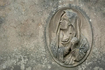The old sandstone bas-relief of the Virgin Mary