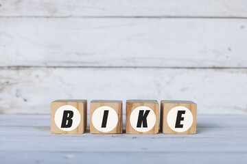 bike concept written on wooden cubes or blocks, on white wooden background.