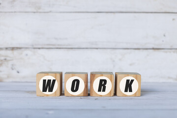work concept written on wooden cubes or blocks, on white wooden background.