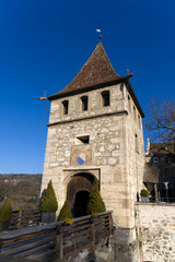 Fototapeta na wymiar Gate tower of Laufen Castle above famous and spectacular Rhine Falls on a sunny spring day. Photo taken March 5th, 2022, Laufen-Uhwiesen, Switzerland.