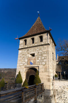 Gate tower of Laufen Castle above famous and spectacular Rhine Falls on a sunny spring day. Photo taken March 5th, 2022, Laufen-Uhwiesen, Switzerland.