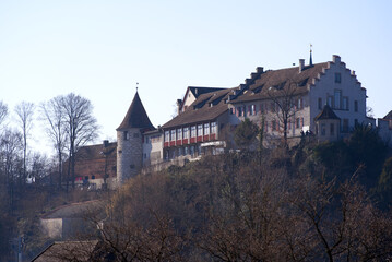 Fototapeta premium Laufen Castle on a hill above the famous Rhine Falls on a sunny spring day. Photo taken March 5th, 2022, Laufen-Uhwiesen, Switzerland.