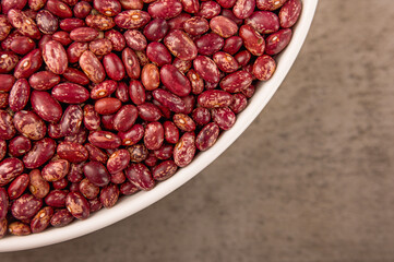 Red beans on white plate, wooden pattern