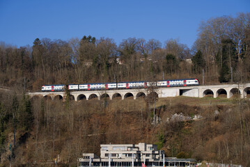 Obraz premium Railway viaduct at Neuhausen am Rheinfall on a sunny spring day near the famous Rhine Falls. Photo taken March 5th, 2022, Neuhausen am Rheinfall, Switzerland.