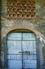 Front door of a barn in an old farmhouse in Castelnuovo Garfagnana, Tuscany, Italy