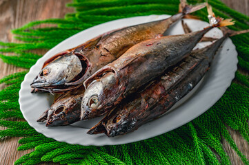 Freshly caught fish, young tuna smoked on white plate, horizontal view