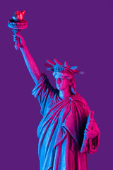 Statue of liberty close up with neon illumination background. USA freedom futuristic concept.