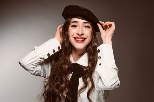 Happy elegant female model in beret