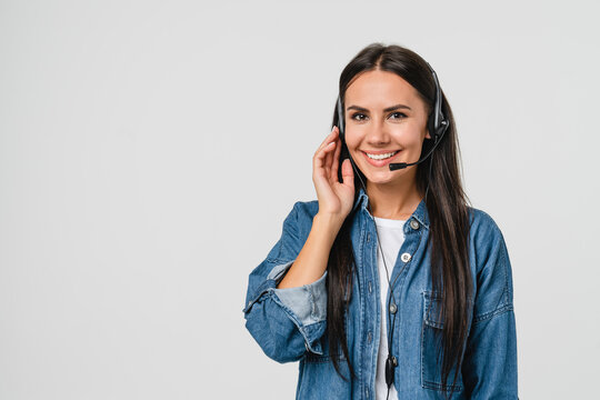 Young friendly caucasian woman IT support customer support agent hotline helpline worker in headset looking at camera while assisting customer client isolated in white background
