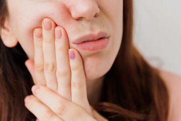 Young handsome young woman expression of horrible suffer from toothache, standing over isolated...