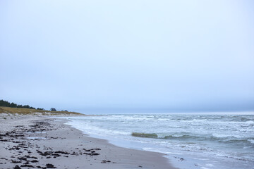 Old red lighthouse near Baltic sea in Latvia, called Akmensraga lighthouse.