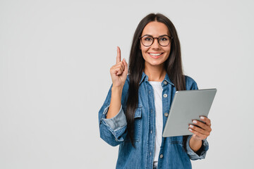 Smiling caucasian young woman girl freelancer student using digital tablet, having idea, pointing...