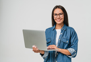 Young smiling caucasian student freelancer woman using laptop for remote work, e-learning at...