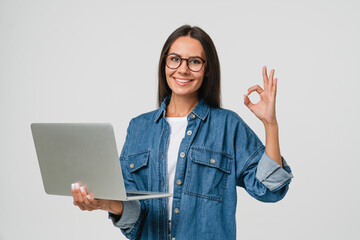 Young smiling caucasian student freelancer woman using laptop for remote work, e-learning at...