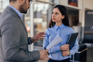 Business people, talking to each other, working on the new project.