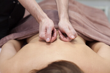 Fototapeta na wymiar Closeup beautiful woman having deep back neck head massage. View from above