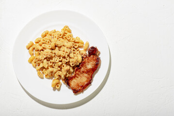 Figured Italian pasta in sauce. Pieces of chopped fried meat. Minimalistic food design. White background.