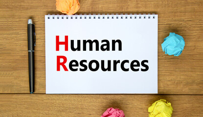 HR Human resources symbol. Concept words HR Human resources on white note. Metallic pen. Beautiful wooden background. Business and HR human resources concept.