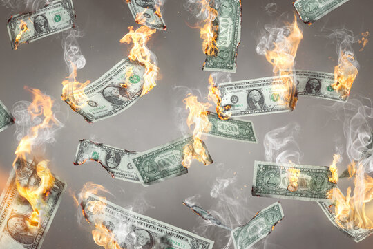 Burning US Dollar notes are falling down