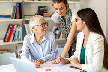 Group of successful business women working together in office. Business people meeting concept.