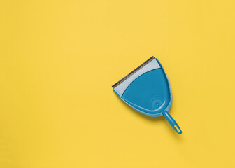 A blue scoop on a bright yellow background. Flat lay.