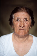 Portrait of an elderly woman in the studio close-up on a dark background.