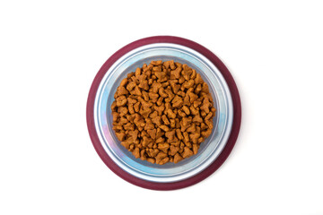 Obraz na płótnie Canvas Dry food for cats and dogs in a red bowl on a white background, top view 
