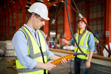 Two young engineers Testing and checking the operation of the semi gantry crane