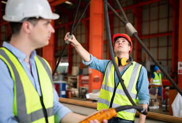 Two young engineers Testing and checking the operation of the semi gantry crane