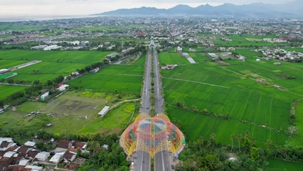 Fotobehang Aerial view of the city colorful Monument Tembolak Rainbow and Mataram City metro monument. The newest icon from the city of Mataram Indonesia. Lombok, Indonesia, March 22, 2022 © syahrir